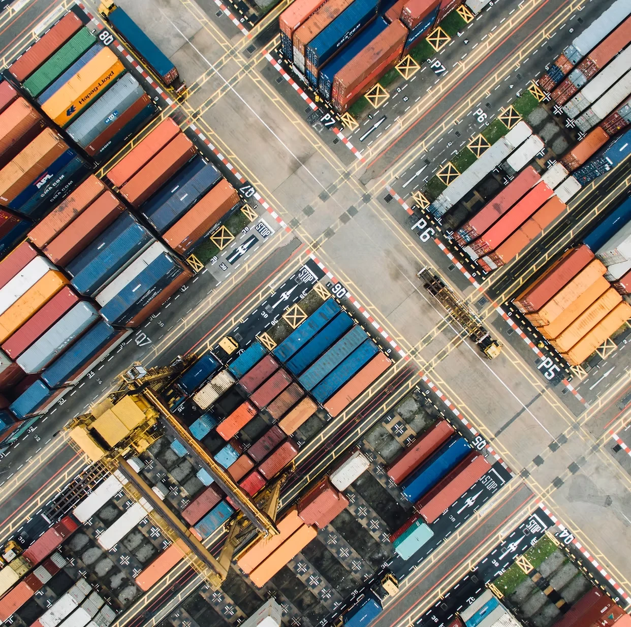 Aerial view of stacked shipping containers at a port terminal
